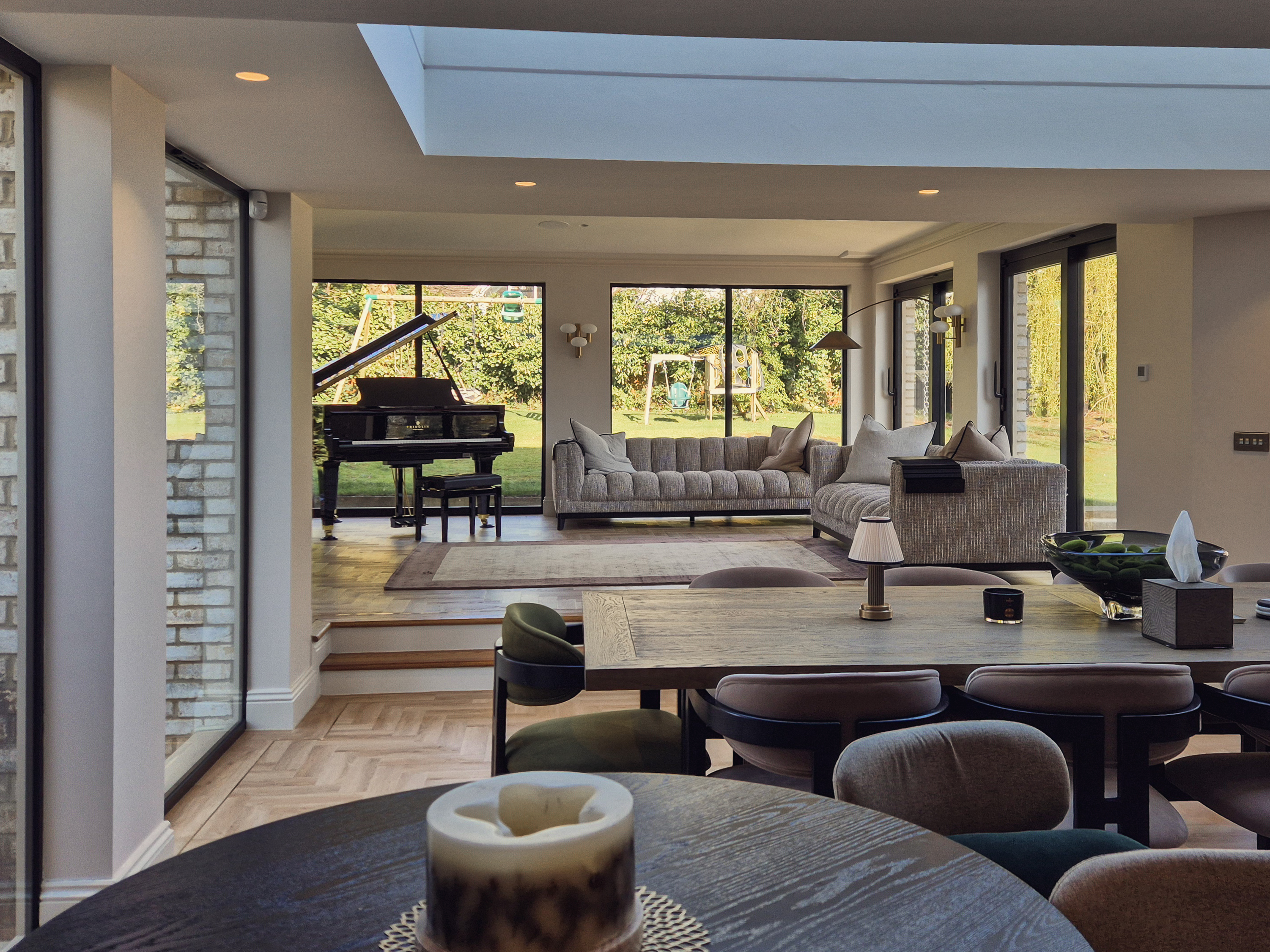 Large-format colour-matched sliding glass doors opening the lounge onto the courtyard, Roundhay, Leeds