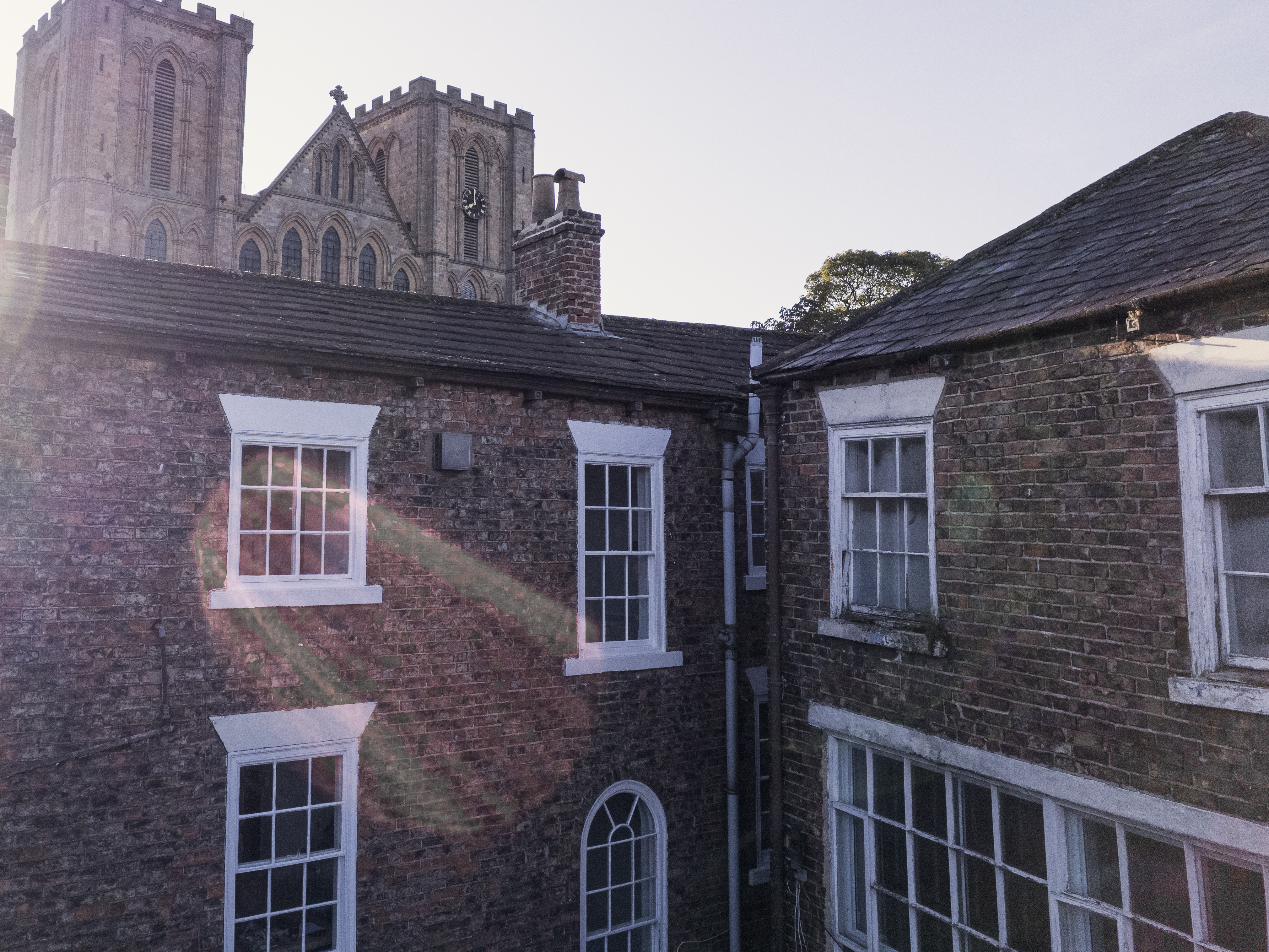 Sympathetic sash window replacement mid-programme in central Ripon: completed windows on the left, originals still to be replaced on the right