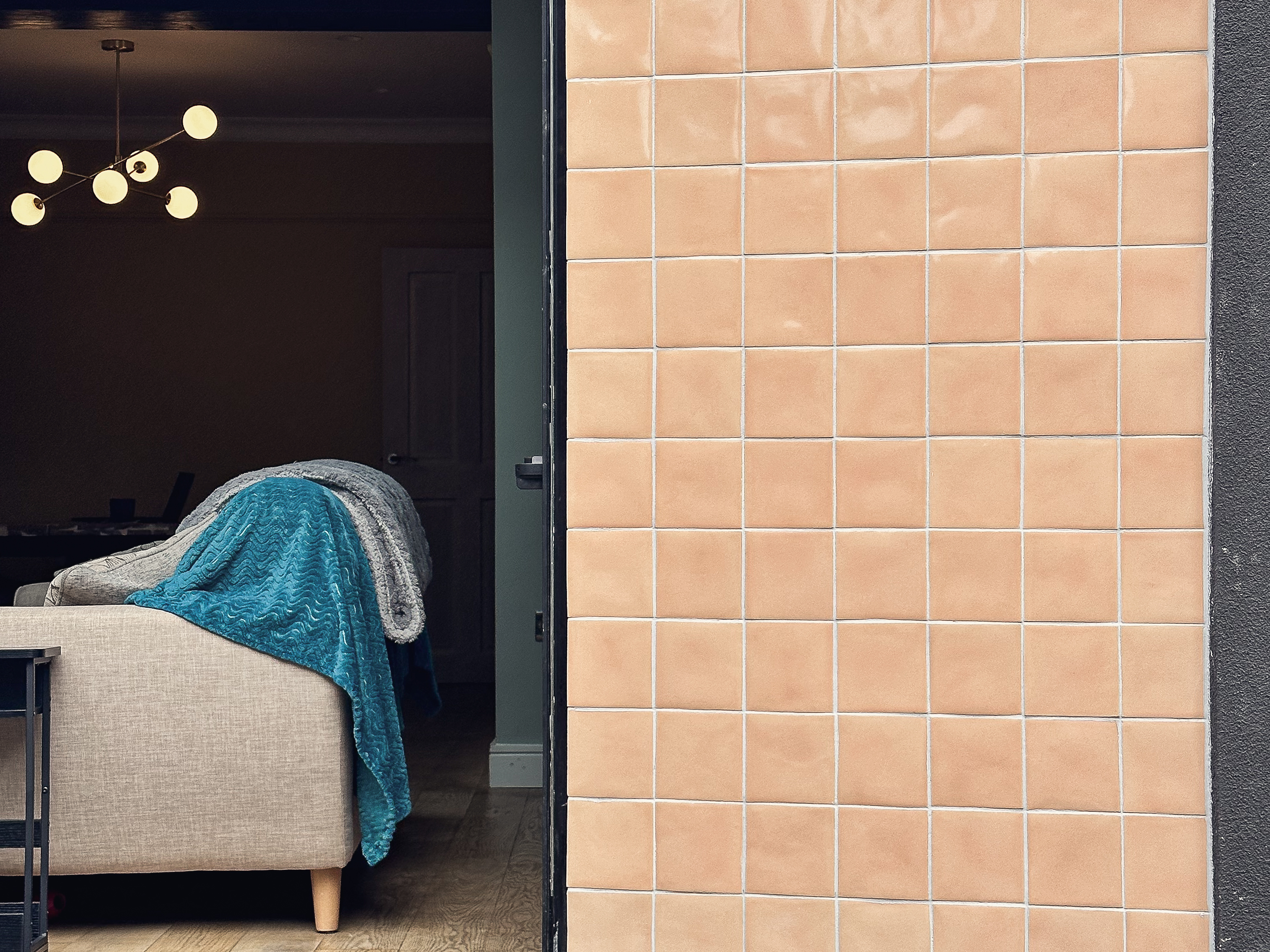Warm apricot Tiles of Stow glazed tiles framing the bifold doors of a rear extension in Roundhay, Leeds